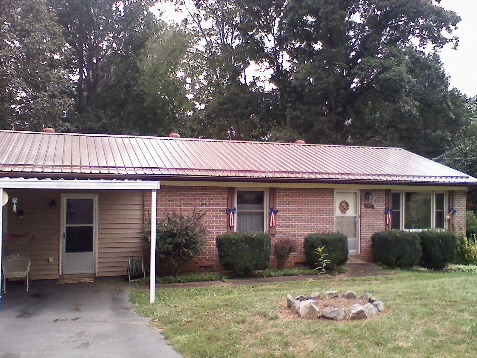 Bronze metal roof and carport on a brick ranch home — Roof Repair work by our crew in Arlington Heights